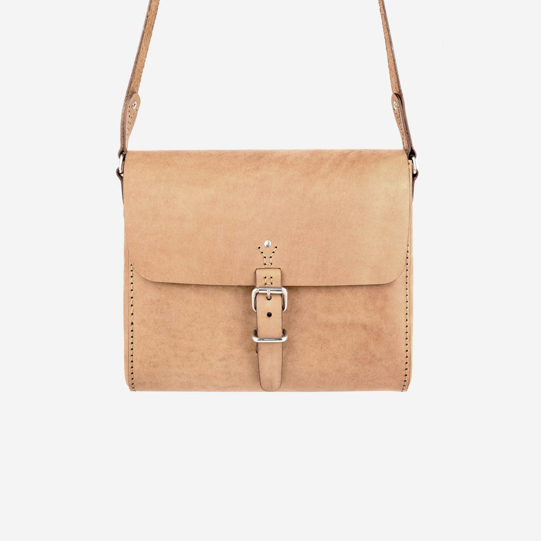 a natural tan leather satchel with hand stitched detailing, stainless steel hardware closures and a shoulder strap